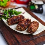 lula-kebab-lavash-wooden-board-greens-side-view_141793-3153_medium