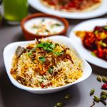 side-view-rice-garnish-with-fried-onion-carrot-greens-chili-pepper-table